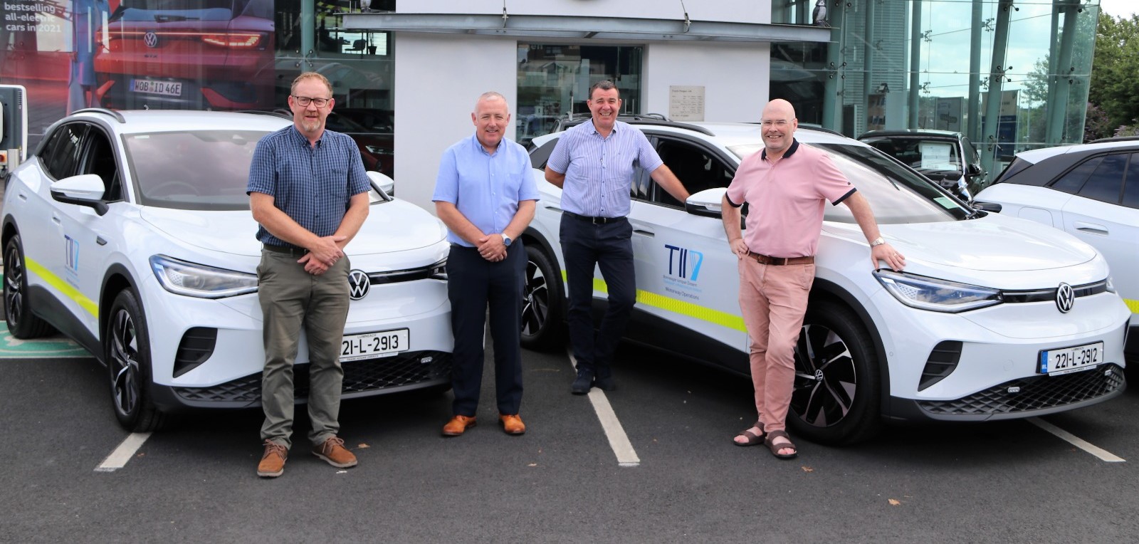 TII staff with EV Fleet of Volkswagen ID. 4 Electric Vehicles